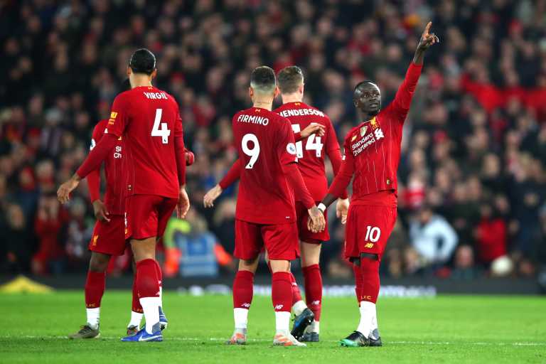 Sadio Mane celebrates with his Liverpool team mates, after scoring the winning goal in the 1-0 win over Wolves. which now sees Liverpool 13 points clear at the top of the Premier League
